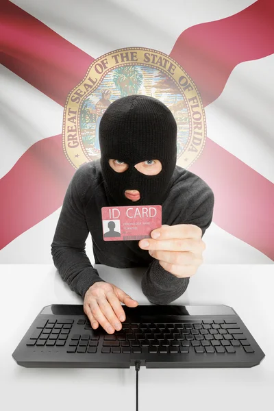 Hacker with USA states flag on background and ID card in hand - Florida —  Fotos de Stock
