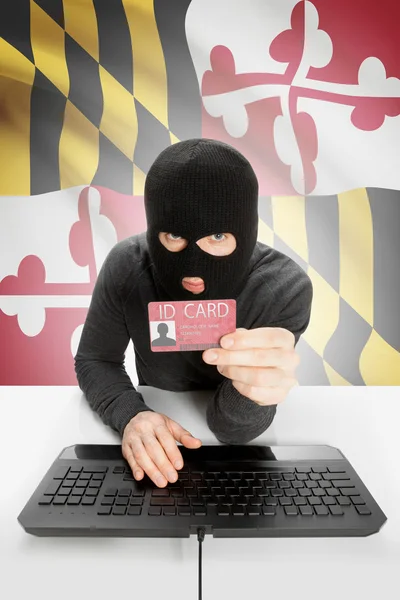 Hacker with USA states flag on background and ID card in hand - Maryland