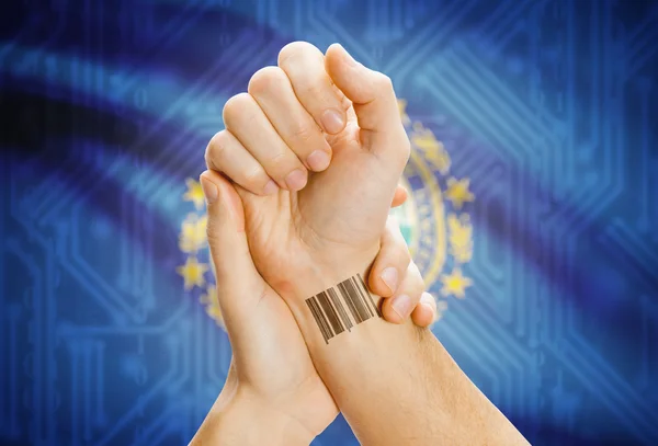 Barcode ID number on wrist and USA states flags on background - New Hampshire — Stok fotoğraf