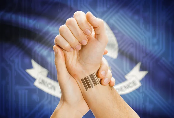 Barcode ID number on wrist and USA states flags on background - Louisiana — 图库照片