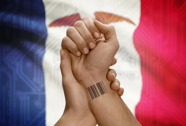 Barcode ID number on wrist of dark skinned person and USA states flags on background - Iowa — Stockfoto