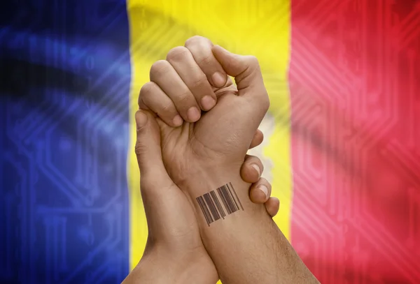 Barcode ID number on wrist of dark skinned person and national flag on background - Andorra — Stock Photo, Image