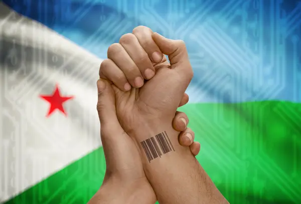 Barcode ID number on wrist of dark skinned person and national flag on background - Djibouti — Stock Photo, Image