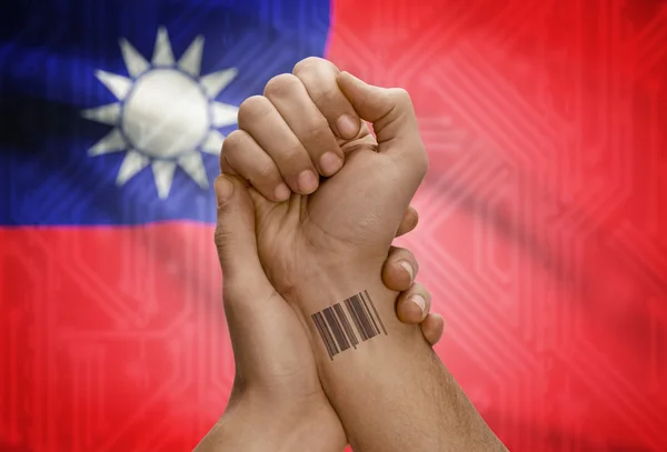 Barcode ID number on wrist of dark skinned person and national flag on background - Taiwan — Foto Stock