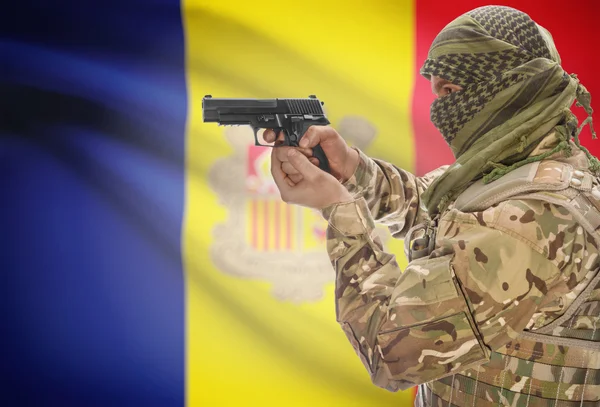 Male in muslim keffiyeh with gun in hand and national flag on background - Andorra — Stockfoto