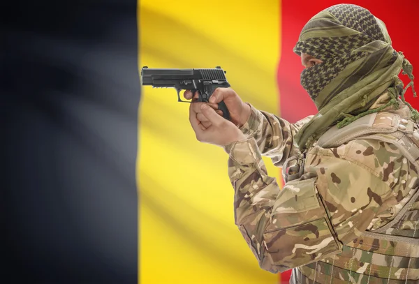 Male in muslim keffiyeh with gun in hand and national flag on background - Belgium — Stockfoto