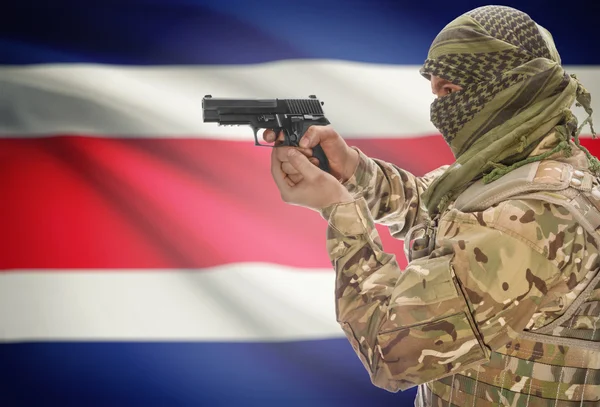 Male in muslim keffiyeh with gun in hand and national flag on background - Costa Rica — Stok fotoğraf
