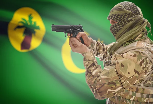 Male in muslim keffiyeh with gun in hand and national flag on background - Cocos (Keeling) Islands — Stock Photo, Image