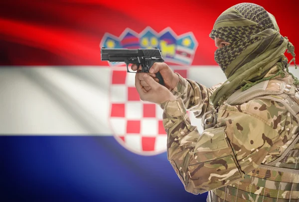 Male in muslim keffiyeh with gun in hand and national flag on background - Croatia — Stock Photo, Image