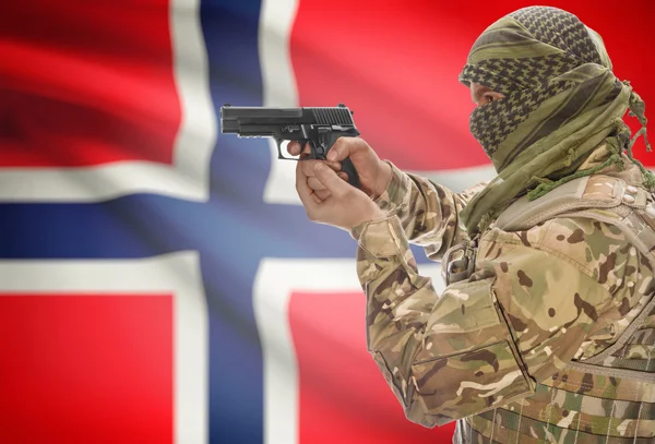 Male in muslim keffiyeh with gun in hand and national flag on background - Norway — 图库照片