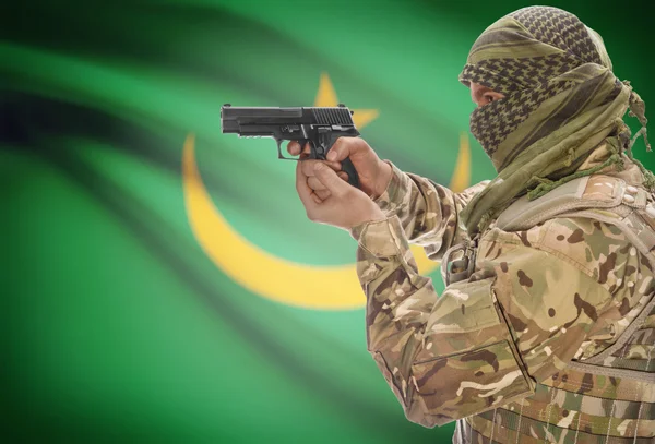 Male in muslim keffiyeh with gun in hand and national flag on background - Mauritania — Stok Foto
