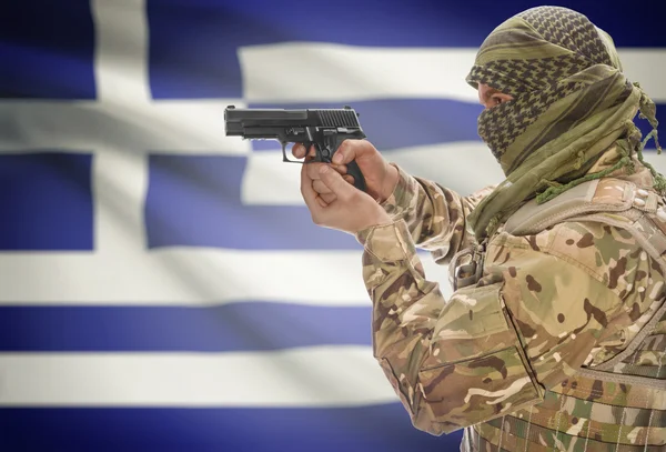 Male in muslim keffiyeh with gun in hand and national flag on background - Greece — 图库照片