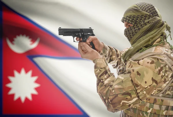 Male in muslim keffiyeh with gun in hand and national flag on background - Nepal — Stock Photo, Image