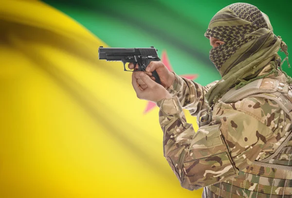 Male in muslim keffiyeh with gun in hand and national flag on background - French Guiana — Stok fotoğraf