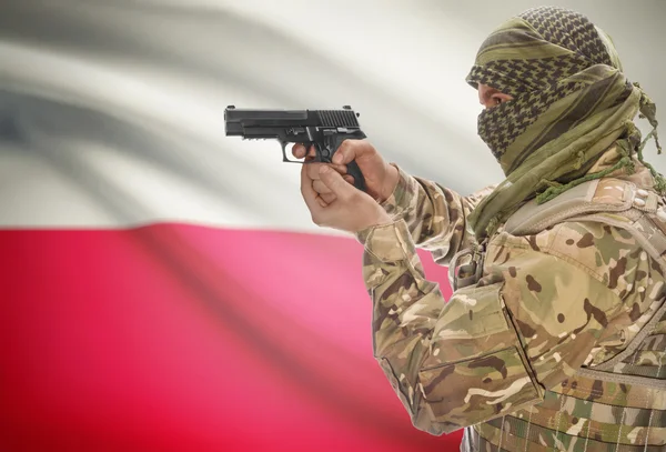 Male in muslim keffiyeh with gun in hand and national flag on background - Poland — Stock Photo, Image