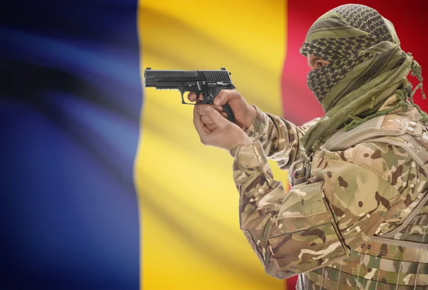 Male in muslim keffiyeh with gun in hand and national flag on background - Romania — 图库照片
