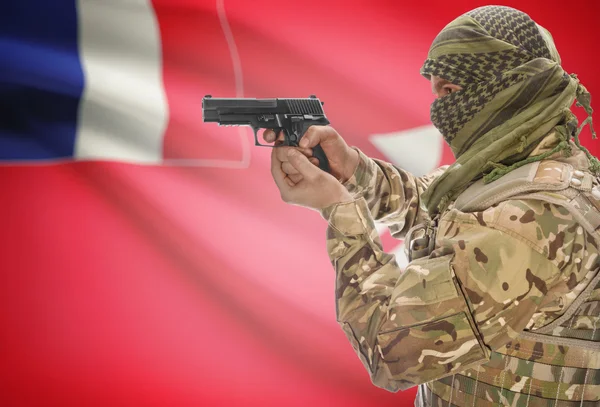 Male in muslim keffiyeh with gun in hand and national flag on background - Wallis and Futuna — стокове фото