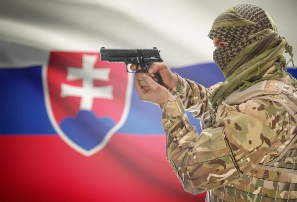 Male in muslim keffiyeh with gun in hand and national flag on background - Slovakia — Foto de Stock