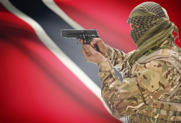 Male in muslim keffiyeh with gun in hand and national flag on background - Trinidad and Tobago — Stok Foto