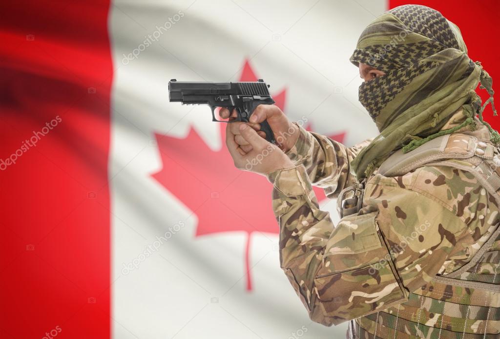 Male in muslim keffiyeh with gun in hand and national flag on background - Canada