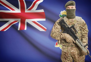 Soldier holding machine gun with flag on background series - Cayman Islands