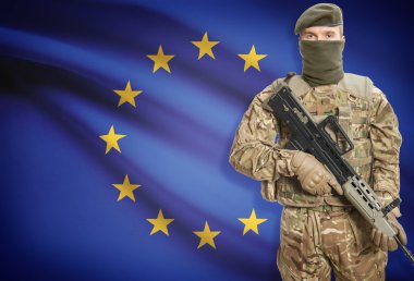 Soldier holding machine gun with flag on background series - European Union - EU