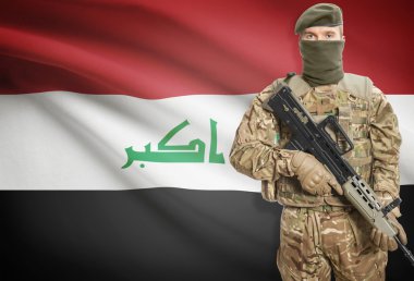 Soldier holding machine gun with flag on background series - Iraq