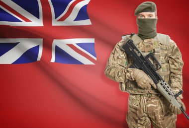 Soldier holding machine gun with Canadian province flag on background series - Manitoba