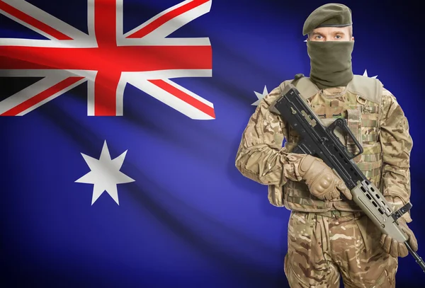 Soldier holding machine gun with flag on background series - Australia — Stockfoto