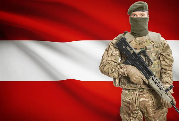 Soldier holding machine gun with flag on background series - Austria — Stock Photo, Image