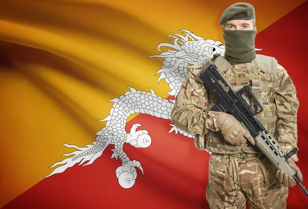 Soldier holding machine gun with flag on background series - Bhutan — Stok Foto