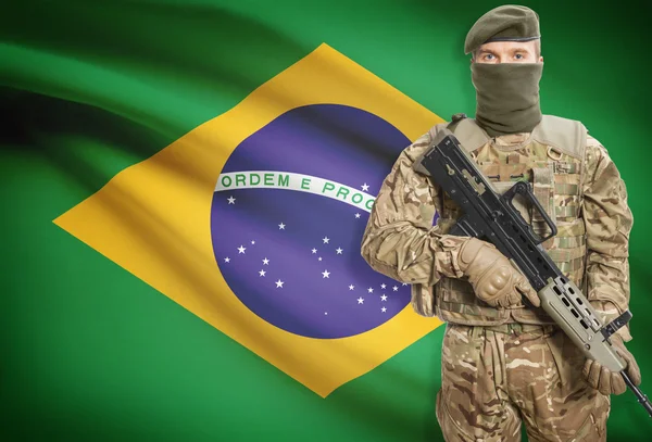 Soldier holding machine gun with flag on background series - Brazil — Foto de Stock