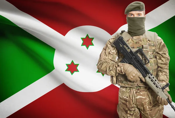 Soldier holding machine gun with flag on background series - Burundi — Stok Foto