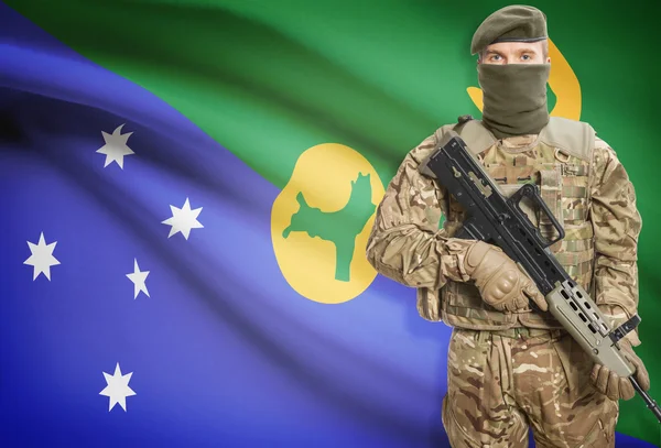 Soldier holding machine gun with flag on background series - Christmas Island — стокове фото