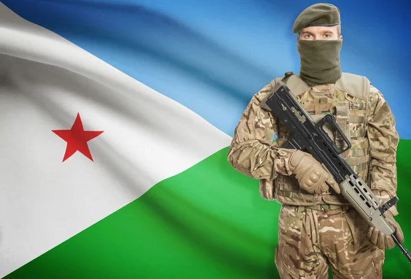 Soldier holding machine gun with flag on background series - Djibouti — Stok Foto