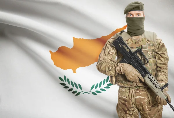 Soldier holding machine gun with flag on background series - Cyprus —  Fotos de Stock