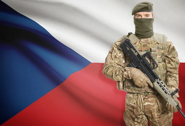 Soldier holding machine gun with flag on background series - Czech Republic – stockfoto