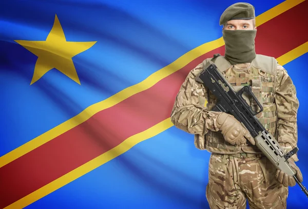 Soldier holding machine gun with flag on background series - Congo-Kinshasa — Zdjęcie stockowe