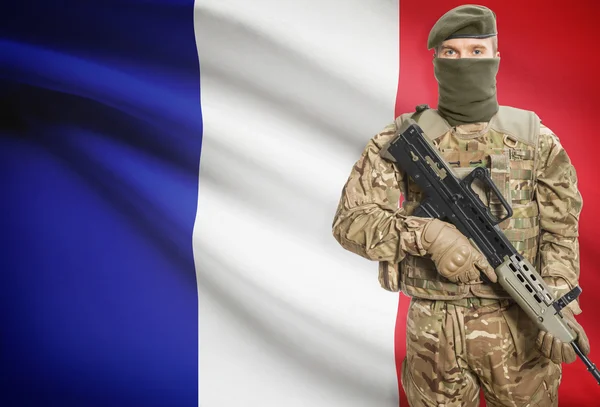 Soldier holding machine gun with flag on background series - France — Stok Foto
