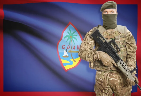 Soldier holding machine gun with flag on background series - Guam — 스톡 사진