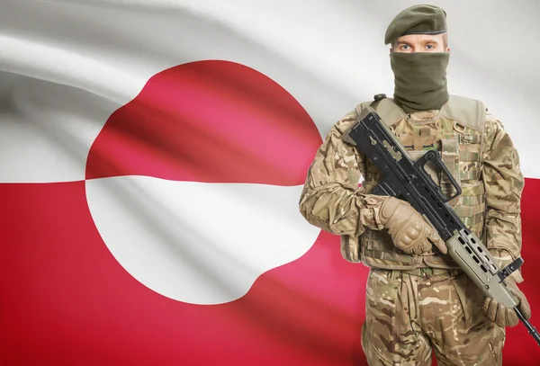 Soldier holding machine gun with flag on background series - Greenland — Stok Foto