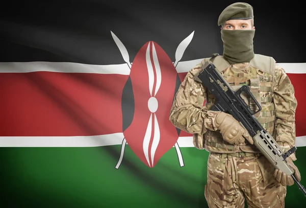 Soldier holding machine gun with flag on background series - Kenya — Stock Photo, Image