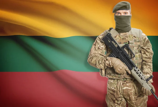 Soldier holding machine gun with flag on background series - Lithuania — Stok Foto