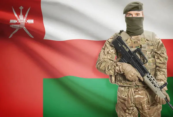 Soldier holding machine gun with flag on background series - Oman — Stok Foto