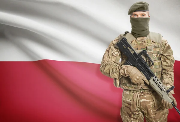 Soldier holding machine gun with flag on background series - Poland — Stok Foto