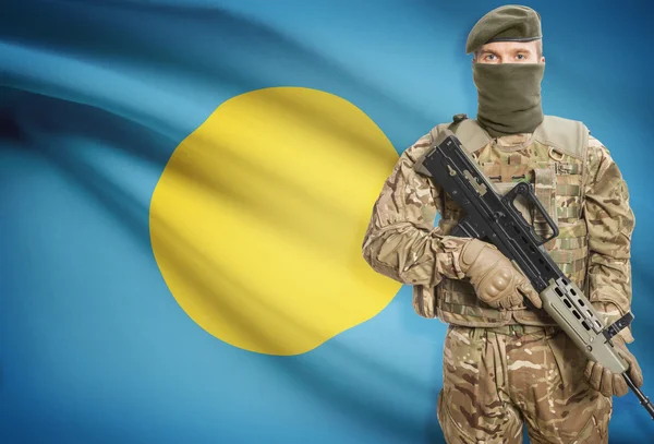 Soldier holding machine gun with flag on background series - Palau — Stok Foto