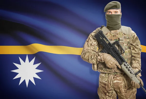 Soldier holding machine gun with flag on background series - Nauru — стокове фото