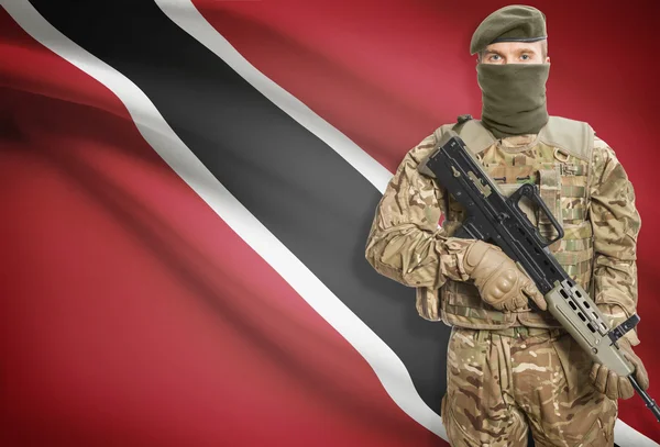 Soldier holding machine gun with flag on background series - Trinidad and Tobago — стокове фото