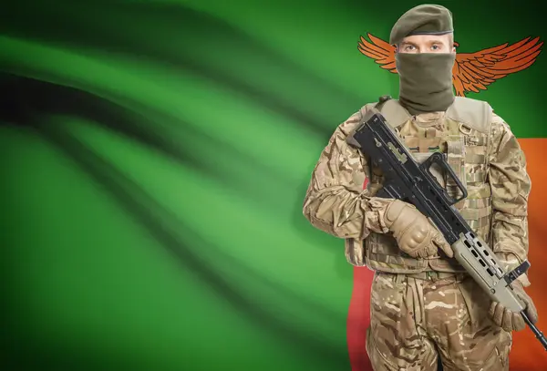Soldier holding machine gun with flag on background series - Zambia — Stok Foto