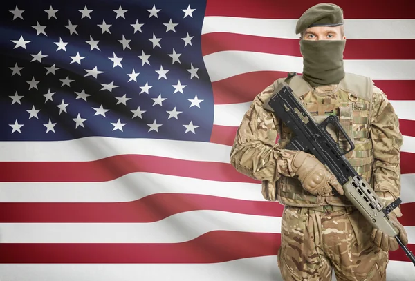 Soldier holding machine gun with flag on background series - United States — Stockfoto